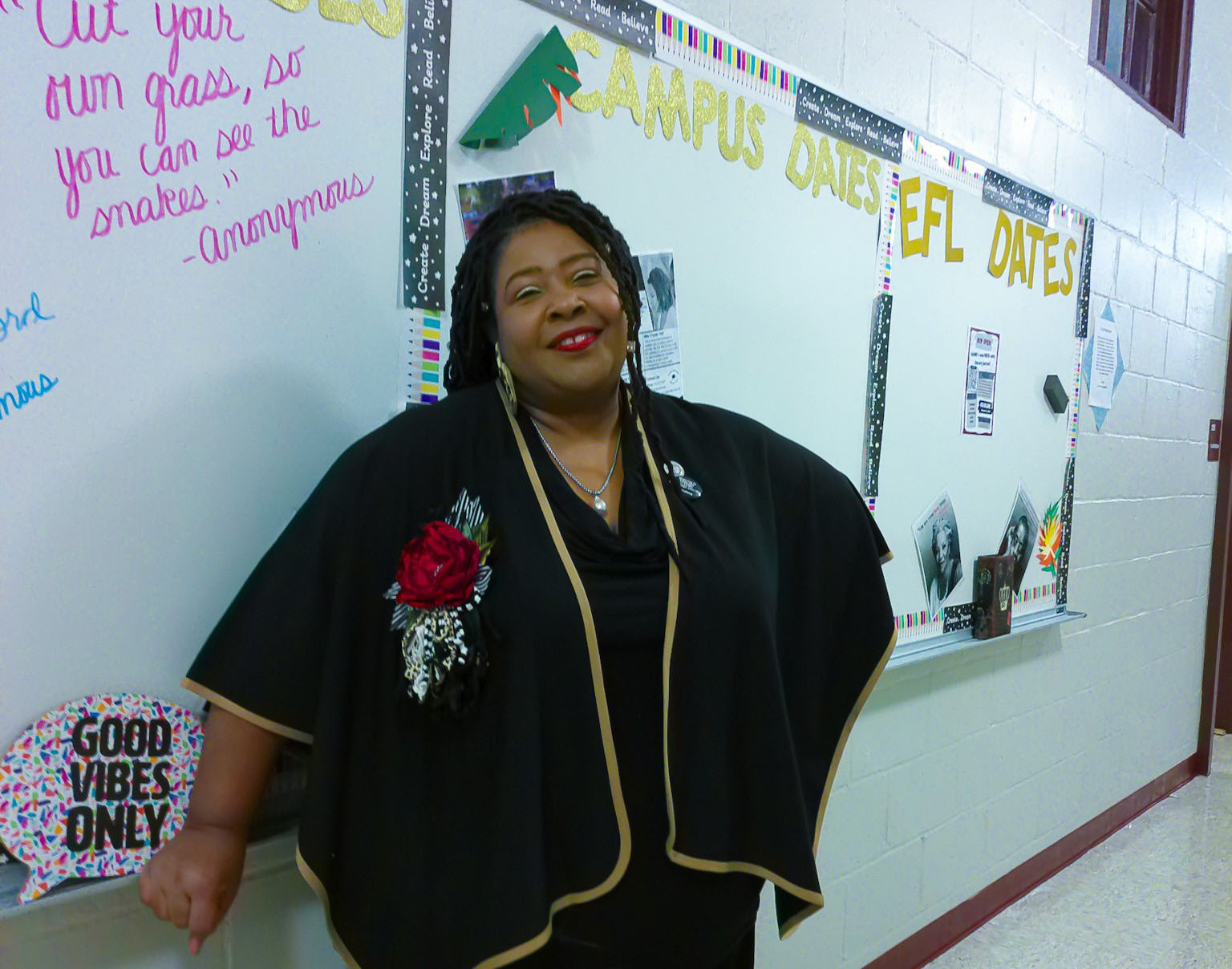 Dr. Charlotte Teague stand in front of a white board near her class