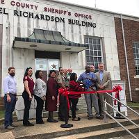 Extension agents, the sheriff's department, and supporters gather for the prescription drug dropbox ribbon cutting.