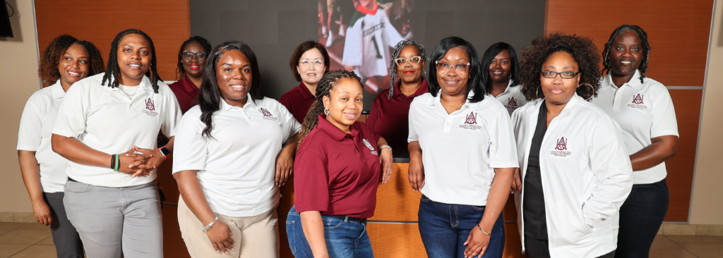 Smiling undergraduate social work students at an event