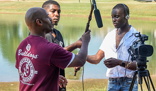 Communications Media students and instructor work with video and audio equipment